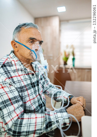 Elderly man receiving oxygen therapy at home in comfort 132296061