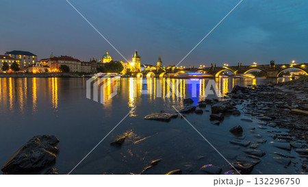 The Charles Bridge day to night timelapse over the Vltava River reflected in water in Prague, Czech Republic The Charles Bridge day to night timelapse over the Vltava River reflected in water in Prague, Czech Republic 132296750