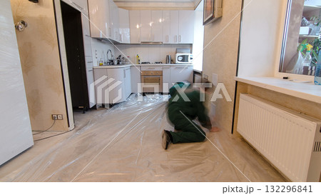 Carpenter worker installing substrate before wood parquet board during flooring work timelapse Carpenter worker installing substrate before wood parquet board during flooring work timelapse 132296841