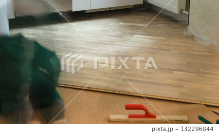 Carpenter worker installing substrate before wood parquet board during flooring work timelapse Carpenter worker installing substrate before wood parquet board during flooring work timelapse 132296844