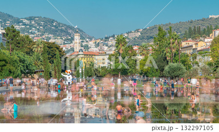 People walk on a Promenade du Paillon park timelapse, famous with its flat fountains in Nice, France. 132297105