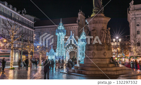 Night timelapse hyperlapse of Christmas decorations with illuminated castle on Luis de Camoes square in Lisbon, Portugal. 132297332