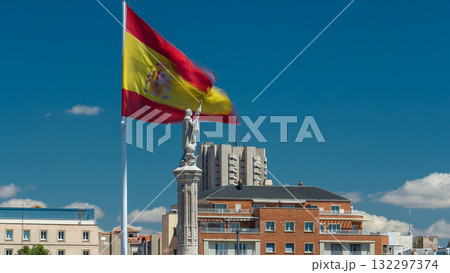 Spanish flag waves behind statue of Christopher Columbus timelapse, plaza de Colon in Madrid, Spain Spanish flag waves behind statue of Christopher Columbus timelapse, plaza de Colon in Madrid, Spain 132297374