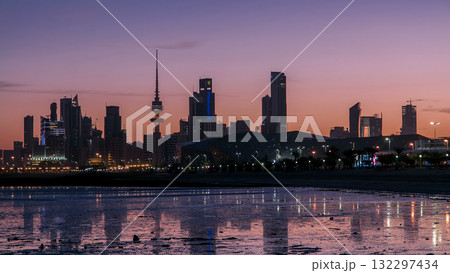Seaside skyline of Kuwait city from night to day timelapse 132297434