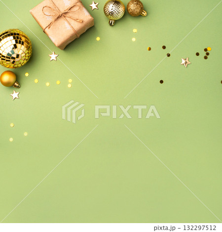 Christmas gift with ornaments on a green background 132297512