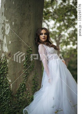 young beautiful girl bride in elegant wedding dress in park 132297776