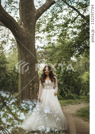 young girl bride in a white dress in a spring forest on a wedding day young girl bride in a white dress in a spring forest on a wedding day 132297784