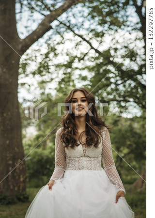 young girl bride in a white dress in a spring forest on a wedding day 132297785