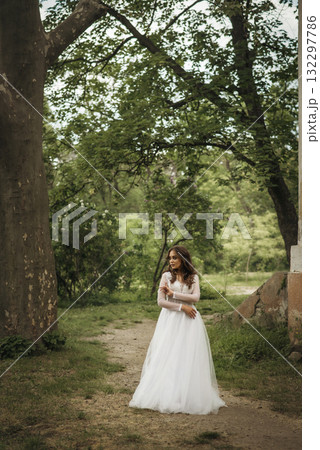 young girl bride in a white dress in a spring forest on a wedding day young girl bride in a white dress in a spring forest on a wedding day 132297786