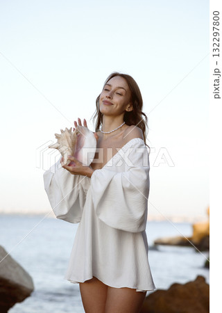 A woman standing in front of water 132297800