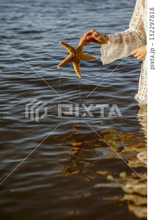 Hand holding starfish with beautiful tropical summer sand beach island, Hand holding starfish with beautiful tropical summer sand beach island, 132297818