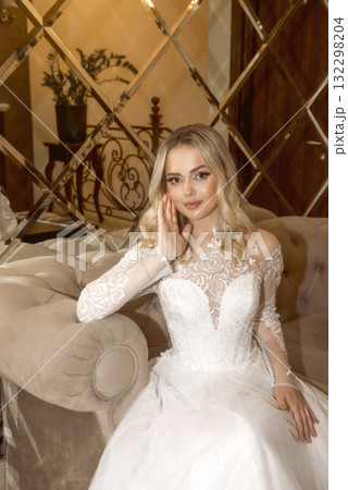 close up of beautiful blonde bride in long white dress at hotel close up of beautiful blonde bride in long white dress at hotel 132298204