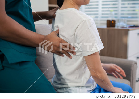 woman doing exercise at clinic with physiotherapist. help of a therapist trainer during a rehabilitation session. 132298778