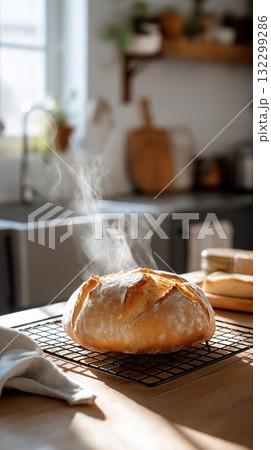 Freshly baked artisan bread cooling on a wire rack with steam rising in a sunlit kitchen Freshly baked artisan bread cooling on a wire rack with steam rising in a sunlit kitchen 132299286