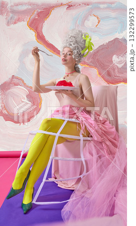 Glamorous Marie Antoinette woman enjoying dessert in cinematic pink setting with confidence 132299573