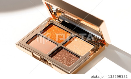 A luxurious metallic eyeshadow palette with a variety of shimmery captivating shades opened at an alluring angle to showcase its elegant high end design 132299581