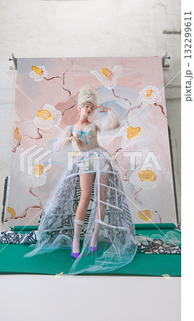 Rococo woman in corset posing confidently against artistic floral backdrop 132299611