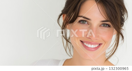 Woman with dark hair displays a bright smile showcasing a relaxed and friendly demeanor Woman with dark hair displays a bright smile showcasing a relaxed and friendly demeanor 132300965