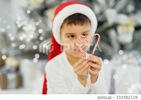 Adorable Child with paper wrapped present. Christmas gift box in children hands. Hands of little boy with Christmas present. unrecognizable. Adorable Child with paper wrapped present. Christmas gift box in children hands. Hands of little boy with Christmas present. unrecognizable. 132302119