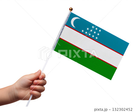 子供の手が小さなウズベキスタンの国旗を持っている。 132302452
