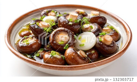 Glazed shiitake mushrooms with pearl onions, garlic, and fresh herbs in savory sauce on ceramic plate. Asian inspired gourmet vegetarian appetizer dish Glazed shiitake mushrooms with pearl onions, garlic, and fresh herbs in savory sauce on ceramic plate. Asian inspired gourmet vegetarian appetizer dish 132303717