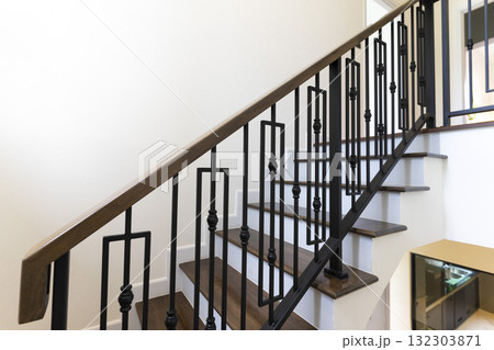 Modern stair case between floors. Stairs with metallic rail in modern building Modern stair case between floors. Stairs with metallic rail in modern building 132303871