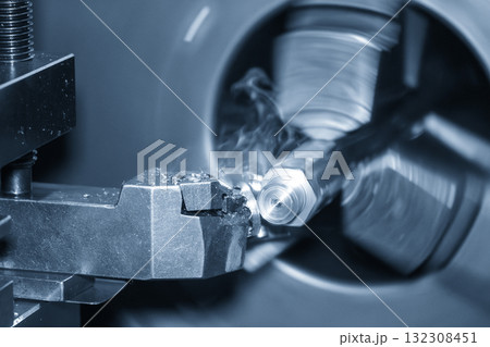 Close up scene the lathe machine finish cut metal shaft parts in blue scene. 132308451
