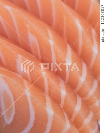 Fresh salmon fillets with vibrant orange color and white marbling, showcasing quality and texture of fish. Perfect for sushi or grilling 132308817