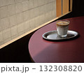 glass of coffee on silver tray sits on maroon table, with textured wall visible through window. scene evokes calm and cozy atmosphere 132308820