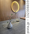 minimalist interior featuring small plant in decorative vase on countertop, with circular light fixture in background, creating serene atmosphere 132308839