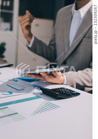 Accounting company provide finance and taxation planning for profitable cash flow, Auditor and accountant team working in office, analyze financial data and accounting record with calculator.Insight Accounting company provide finance and taxation planning for profitable cash flow, Auditor and accountant team working in office, analyze financial data and accounting record with calculator.Insight 132309267