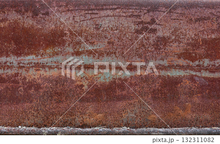 The metal panel is made of iron and has been weathered over time, resulting in a rough and textured surface. The rust has formed in a red color, giving the panel a grunge and industrial feel. The metal panel is made of iron and has been weathered over time, resulting in a rough and textured surface. The rust has formed in a red color, giving the panel a grunge and industrial feel. 132311082