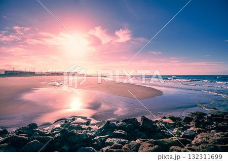 Seascape in the evening at low tide. Seacoast of Costa da Caparica city at sunset. Portugal Seascape in the evening at low tide. Seacoast of Costa da Caparica city at sunset. Portugal 132311699