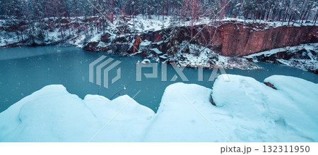 The lakeshore is covered with snow in winter. View of the beautiful lake in snowy winter. Horizontal banner 132311950