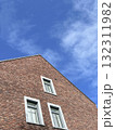 red brick building with white windows over sky 132311982