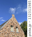 chimney and roof of a brick house over blue sky 132311985