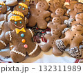 Homemade gingerbread men cookies decorated with colorful icing on Christmas plate 132311989