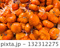 A vibrant pile of small orange pumpkins celebrates the autumn harvest and holidays 132312275