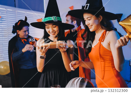 Joyful office Halloween party with coworkers in costumes, celebrating with drinks and laughter, fostering teamwork and festive spirit 132312300