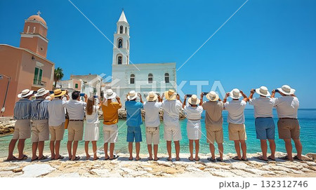 Tourists Capturing a Coastal Church in Sunny Mediterranean Town 132312746