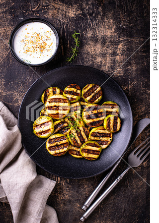 Grilled zucchini with sauce, vegan dish Grilled zucchini with sauce, vegan dish 132314333