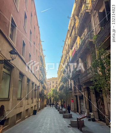 Narrow European Barcelona Street with Historic Buildings and Blue Sky 132314823