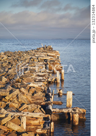 A ruined wooden pier on the blue sea A ruined wooden pier on the blue sea 132314864