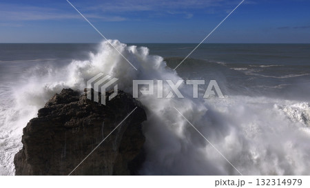 High waves breaking on the rocks of the coastline 132314979