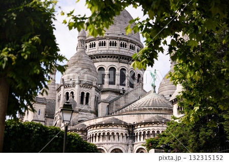 Sacre Coeur Basilica in Montmartre Paris France framed by trees Sacre Coeur Basilica in Montmartre Paris France framed by trees 132315152