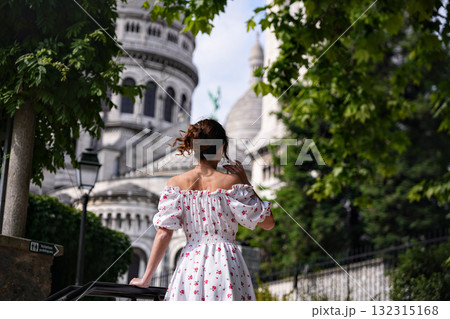 Young woman in floral dress walking near Sacre Coeur Basilica in Paris Young woman in floral dress walking near Sacre Coeur Basilica in Paris 132315168