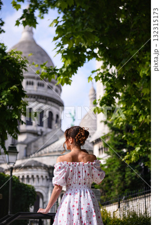 Young woman in floral dress looking at Sacre Coeur Basilica in Montmartre Paris Young woman in floral dress looking at Sacre Coeur Basilica in Montmartre Paris 132315173