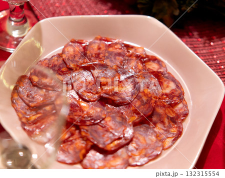 Close up of sliced spanish chorizo sausage on plate 132315554