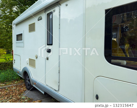 Exploring nature in a cozy camper van during a peaceful afternoon in a scenic park surrounded by vibrant trees Exploring nature in a cozy camper van during a peaceful afternoon in a scenic park surrounded by vibrant trees 132315647