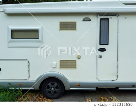 Creative camping adventure with a cozy camper parked in a tranquil natural setting during a bright sunny day Creative camping adventure with a cozy camper parked in a tranquil natural setting during a bright sunny day 132315650